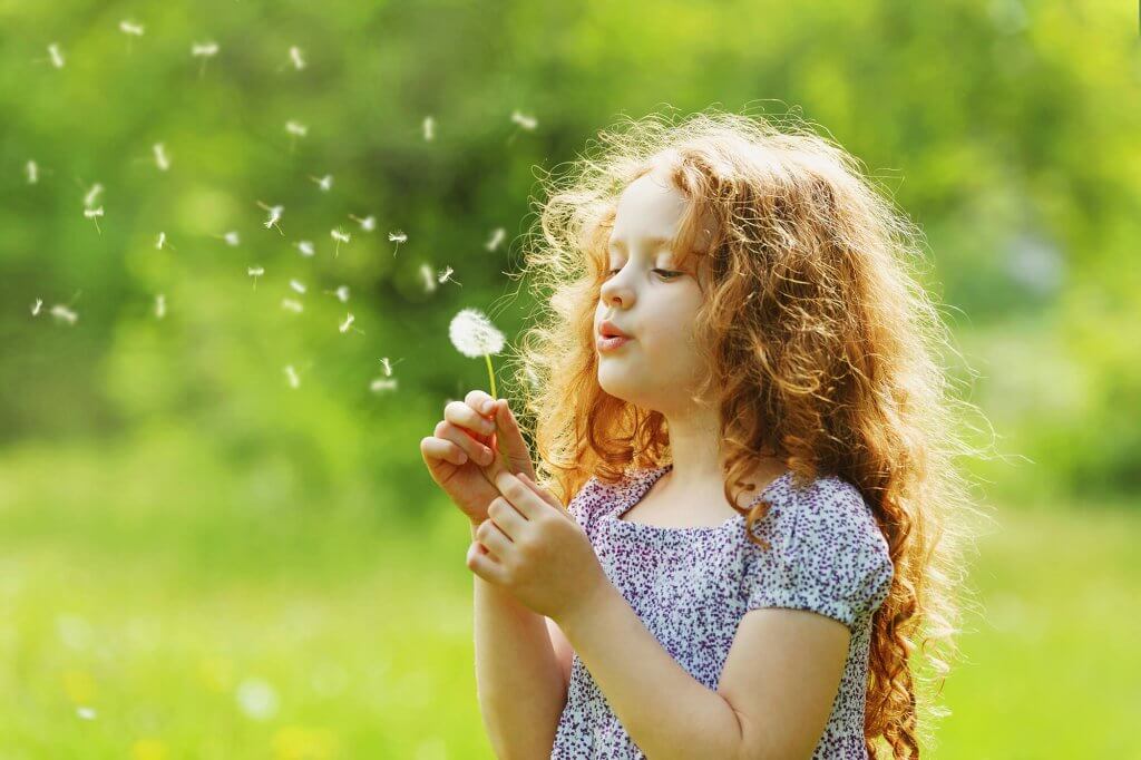 Young girl with dandylion